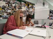 Mackenzie Agnew, left, and Emily Vachter pore over their work in Remy Strapp's Calculus Class. Photo by Jillian Daley