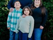 Robert and Tasha Arano beam with their two children: North Marion third-grader Romeo and second-grader Emma. Submitted photo