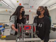 Jessica Alvarez, left, a sophomore, and Ambar Benito, a freshman, joke together during a robotics club meeting after school.