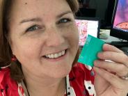 School District Nurse Gina Byers grins as she holds up a lice comb. Photo by Gina Byers