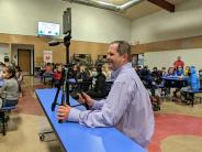 Intermediate School Principal Cory Gaub records a friendly teacher-student competition on March 16.