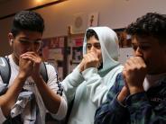 From left, Alexander Guerrero Elais,  Christian Delgado Ortiz  Juruen Delgado do what's usually an Outdoor School whistle.