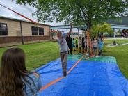 Third-grader Ariel McGee tiptoes on a tightrope over to her best friend, Aleah Curths.