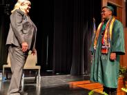 Ime Guzman Martinez pauses on the stairs to smile at Principal De Ann Jenness. Photo by Jillian Daley