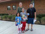 Isabel Betancourt Court Cruz stands with her children: fourth-grader Joshua, kindergartner Ariana, and sixth-grader Giovanni. 