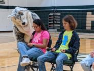 The Husky mascot tries to get ASB President Yadira Romero Navarro’s attention,  while Peter Crosby laughs at the mascot's antics