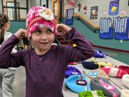 Kindergartner Erina Kuzmin calls the fish button her hat Nemo. Photo by Jillian Daley