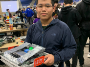 Student holding robot