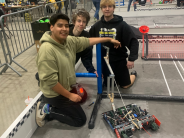 3 students working on robot