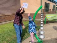 Older student working with young student
