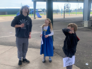 Older student working with 2 young students
