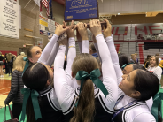 Cheerleaders holding state trophy