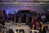 Students cluster around the deejay during prom, held at Aurora Colony Vineyards. Photo by Sara Bailey