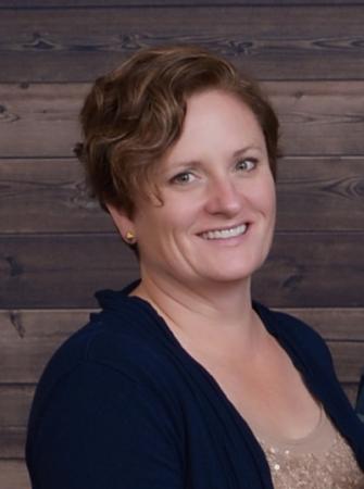 Kristie Buckland, a woman with short brown hair, is smiling. Photo courtesy of Buckland