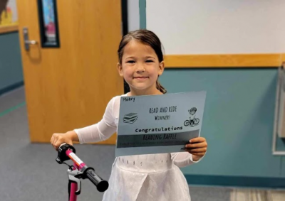 Kindergartner Mabry O’Dell was among the nine winners of the Read and Ride Bike Raffle. Photo by Spring Chang