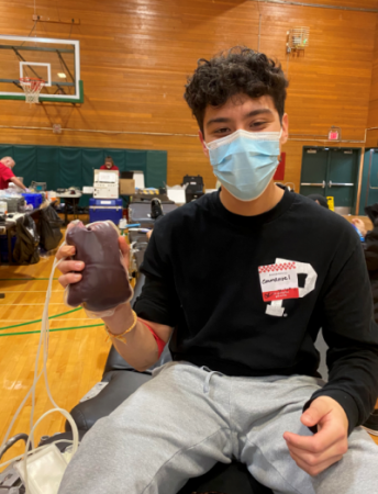 North Marion senior Emmanuel Morales Garcia proudly holds up his blood donation. Photo by Patricia McClintock