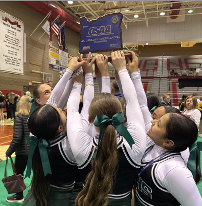 NMHS Cheerleaders holding state trophy