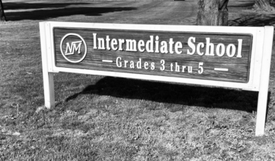 A black and white image of the school sign