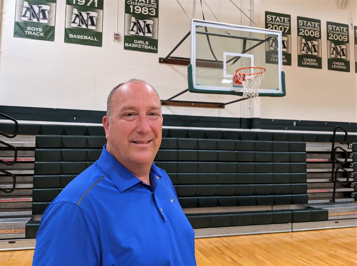 Mark Sundquist stands in a gym at the High School 