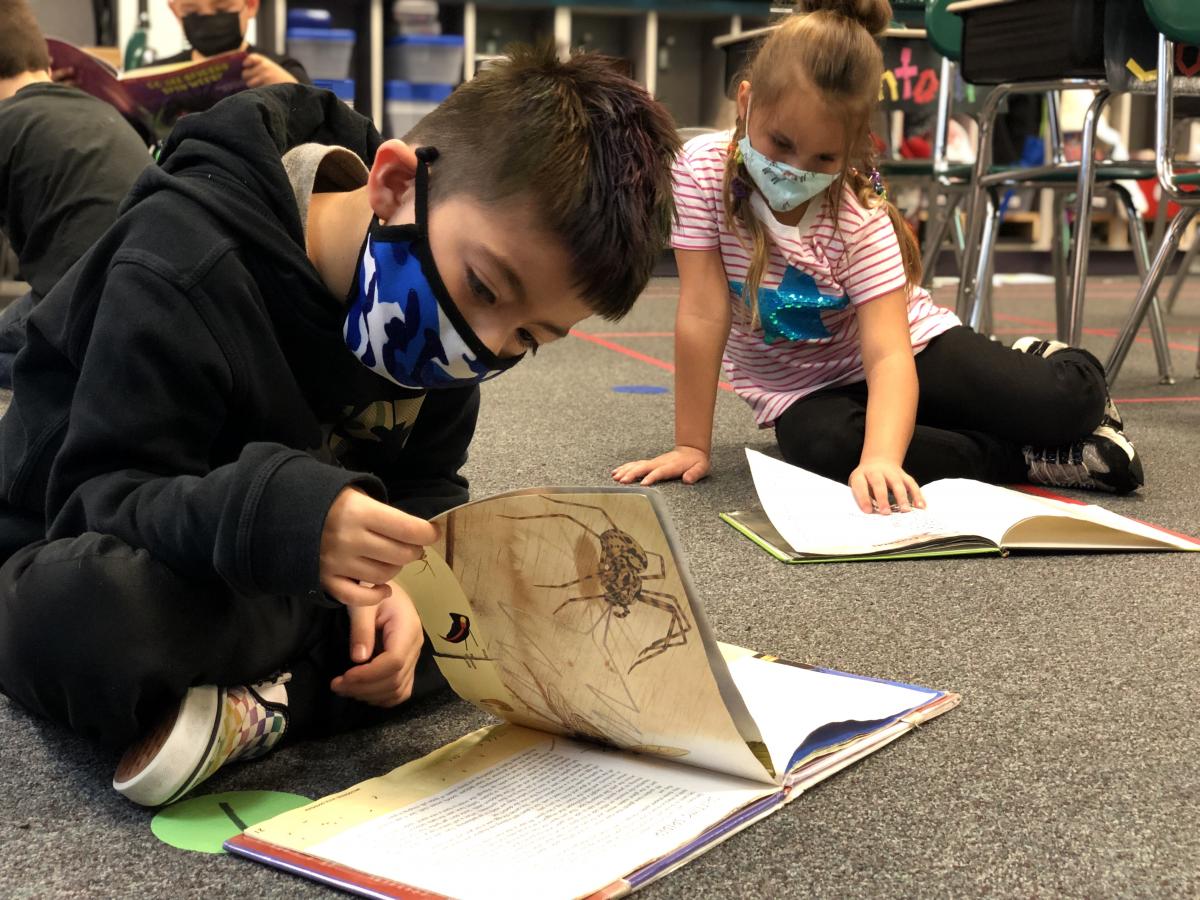 First-graders Estevan and Soraya study arachnids. Photo by Josh Mitchell