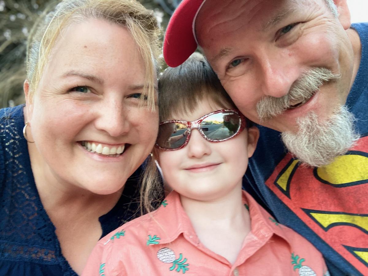 School District Nurse Gina Byers beams with her husband, Bob, and their son, Alex. Photo courtesy of the Byers family