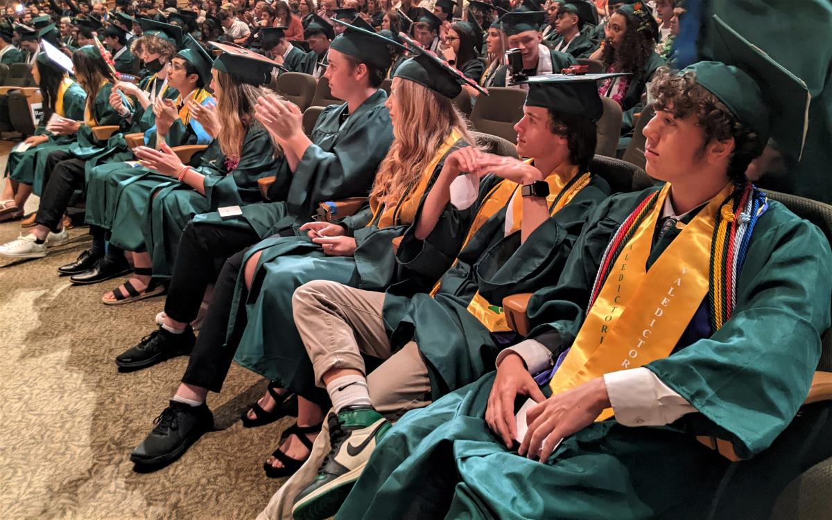 Members of the North Marion Class of 2022 watch as grads receive their diplomas Friday night. 