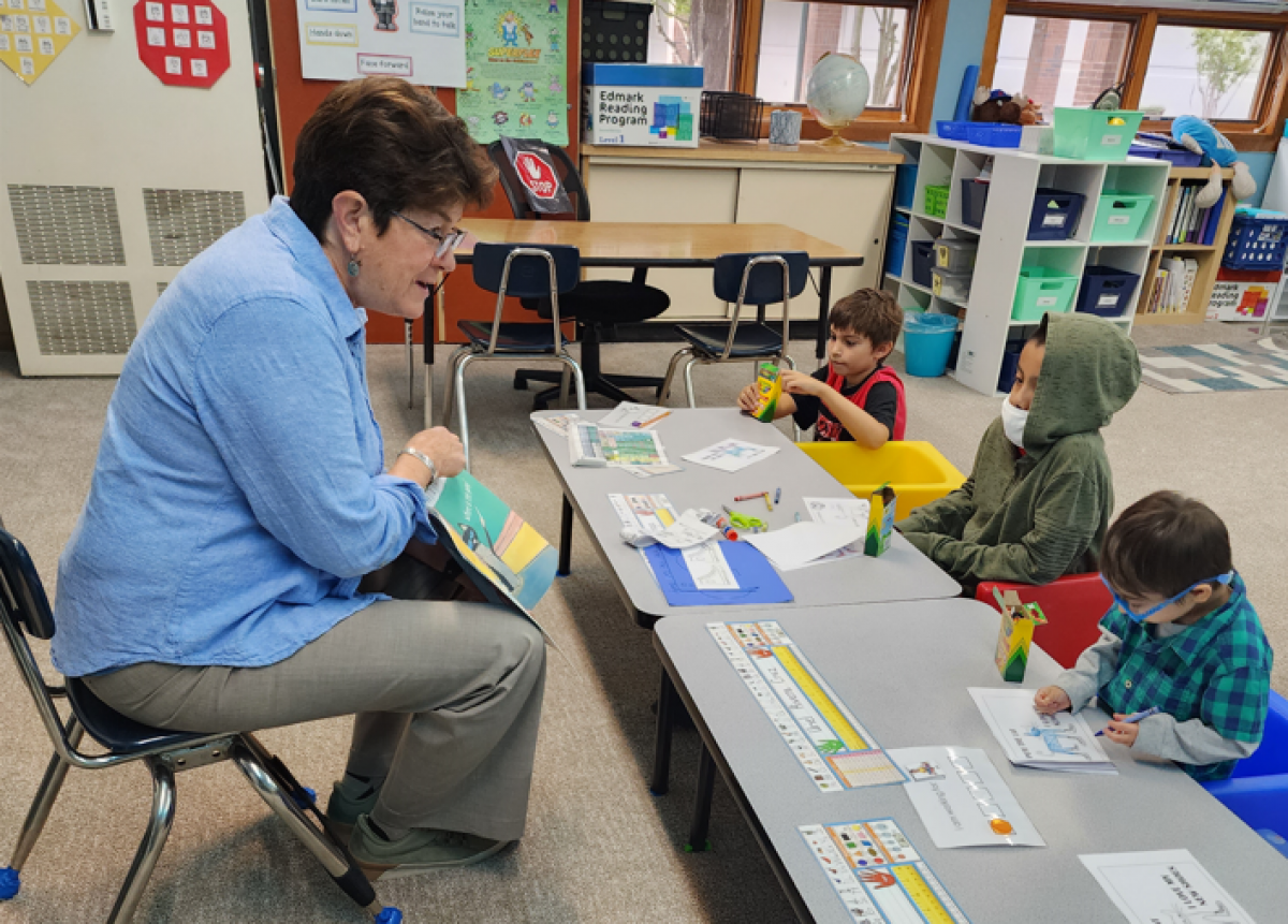 Superintendent Ginger Redlinger makes the time to read in Teacher Tami Esmay's class. Photo by Tami Esmay