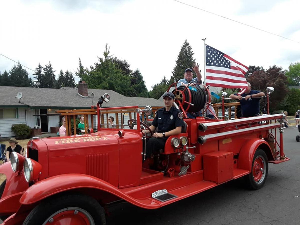 A photo of a classic fire truck rolling along in a parade back in 2018 in the charming city of Aurora