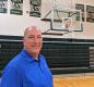 Mark Sundquist stands in a gym at the High School 