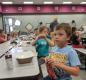 Kelvin Gerdes, 4, bbreaks into a snack during a Jump Start lunch break. Photo by Jillian Daley