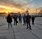 Principal David Sheldon stands proudly with his students during a vibrant sunrise on Tuesday, October 19.