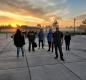 Principal David Sheldon stands proudly with his students during a vibrant sunrise on Tuesday, October 19.