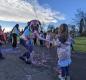 Kindergartner Ellie Jo Hansen unleashes a spider’s web of Silly String upon Teacher Emily Miller wile Jones Quintero looks on. 