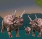 Two triceratops adults with a baby triceratops, which looks like a little dino family
