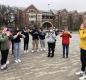 Following the prompting of student ambassador Riley Farrell, AVID students form an O with their hands during a U of O tour.