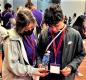 Ashley Delgado and Jonathan Ramirez pause to look at materials during the College and Career Fair. Photo by Rafael Pelaez