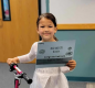 Kindergartner Mabry O’Dell was among the nine winners of the Read and Ride Bike Raffle. Photo by Spring Chang