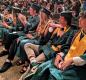 Members of the North Marion Class of 2022 watch as grads receive their diplomas Friday night. 