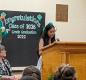 High School Principal De Ann Jenness listens as eighth-grader Yaharit Cisneros Gonzalez delivers her speech. 