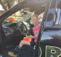 Fifth-grader Joan Bonser takes a moment to enjoy a real police cruiser. Photo by MCSO Deputy Pete Walker