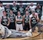 The High School and Middle School teams (and the Husky mascot) pose to celebrate the success of a Nov. 29 basketball fundraiser.