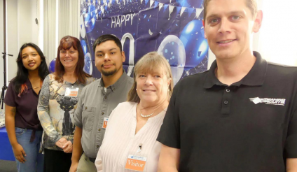 There were smiles all around at Screaming Circuits' 20th anniversary dinner where they presented a donation to the NHMS robotics