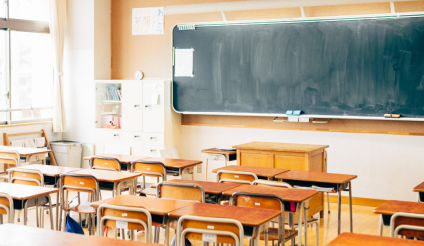 Image of a classroom filled with empty desks